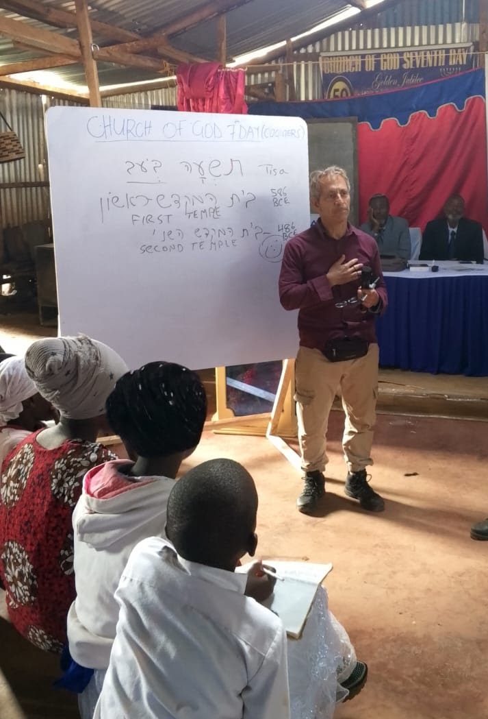 Dan Goldstein teaching a Hebrew reading class at a whiteboard